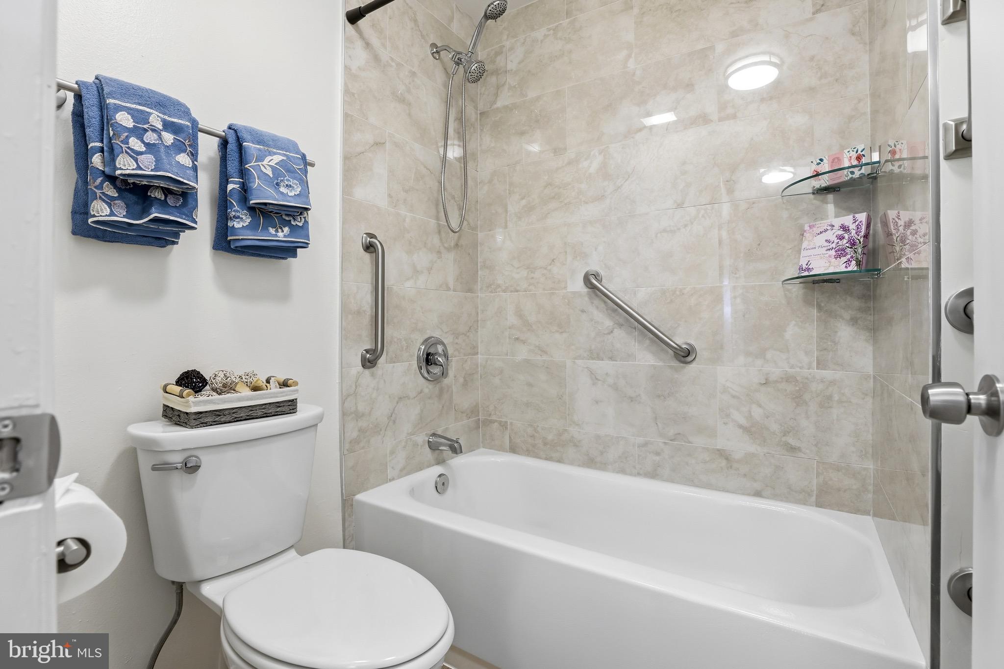 3500 Forest Edge Drive, Unit 152F Silver Spring, MD 20906 - Photo 28 of 31 a white bath tub sitting next to a white toilet and sink