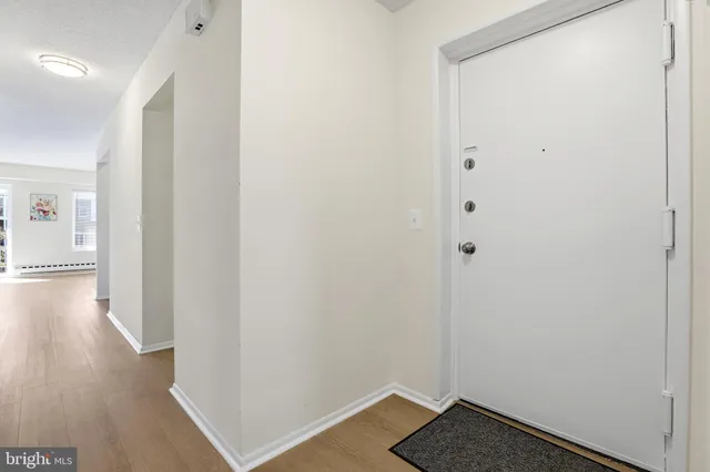 a view of a hallway with wooden floor