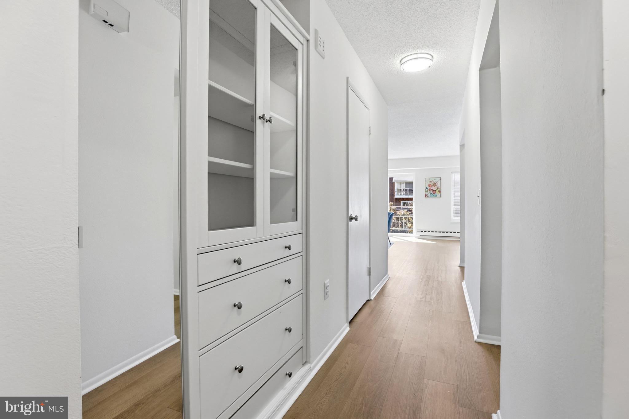 3500 Forest Edge Drive, Unit 152F Silver Spring, MD 20906 - Photo 6 of 31 a view of a hallway with wooden floor