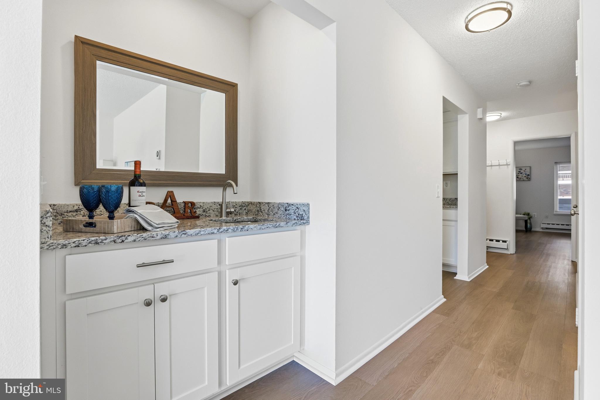 3500 Forest Edge Drive, Unit 152F Silver Spring, MD 20906 - Photo 8 of 31 a bathroom with a granite countertop sink and a mirror