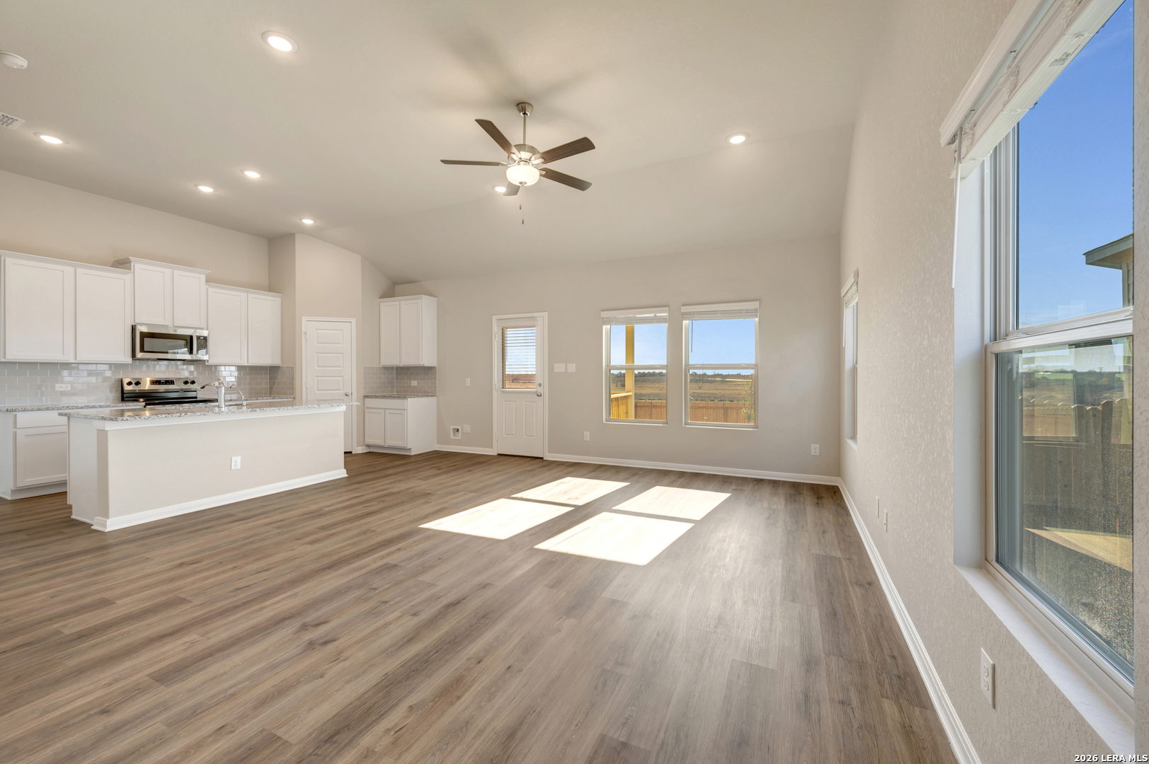 10330 Goodison Drive Converse, TX 78109 - Photo 9 of 42 a view of an empty room with window and wooden floor
