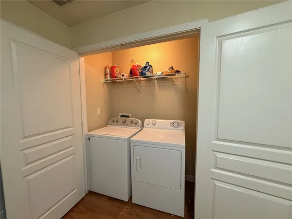 a view of a patio with a table and chairs under an umbrella