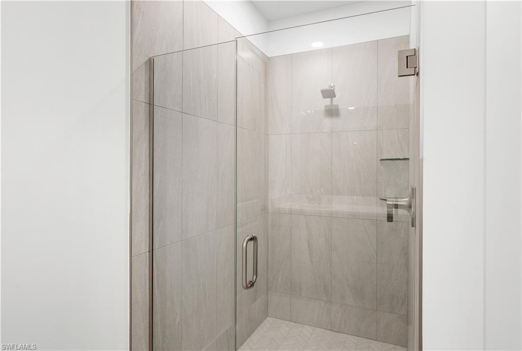 8897 Oceana Way Naples, FL 34114 - Photo 17 of 40 Luxe, walk-in shower with gorgeous shower floor and wall tile