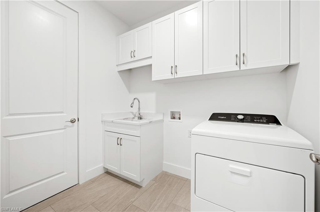 8897 Oceana Way Naples, FL 34114 - Photo 20 of 40 Laundry room with washer and gas dryer