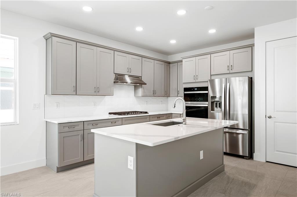 8897 Oceana Way Naples, FL 34114 - Photo 2 of 40 Gorgeous kitchen layout with wood cabinetry and quartz countertops