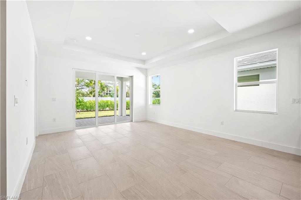 8897 Oceana Way Naples, FL 34114 - Photo 6 of 40 Great room living area with tray ceiling