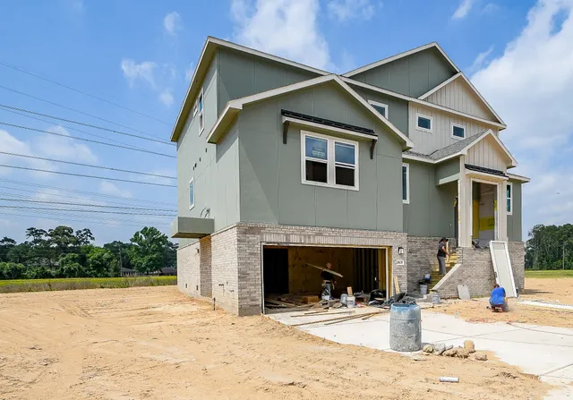 a front view of a house with yard and garage