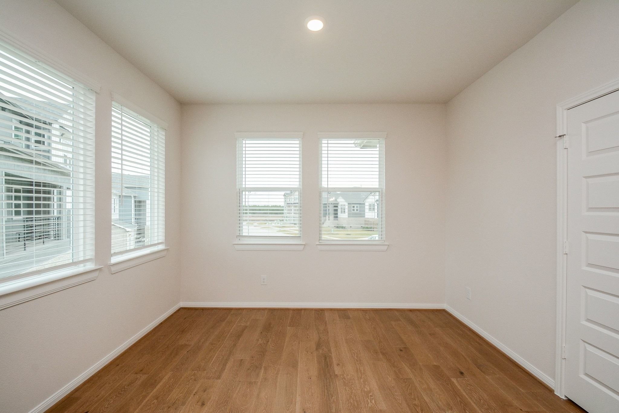 20629 Dynamic Court Humble, TX 77338 - Photo 11 of 36 an empty room with wooden floor and windows
