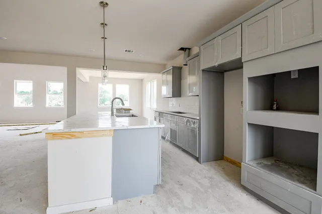 a kitchen with stainless steel appliances a stove refrigerator and cabinets