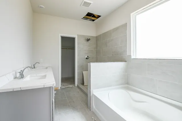 a bathroom with a bathtub and a sink