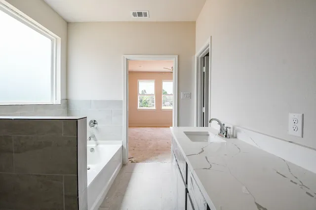 a en suite bathroom with a sink and a mirror