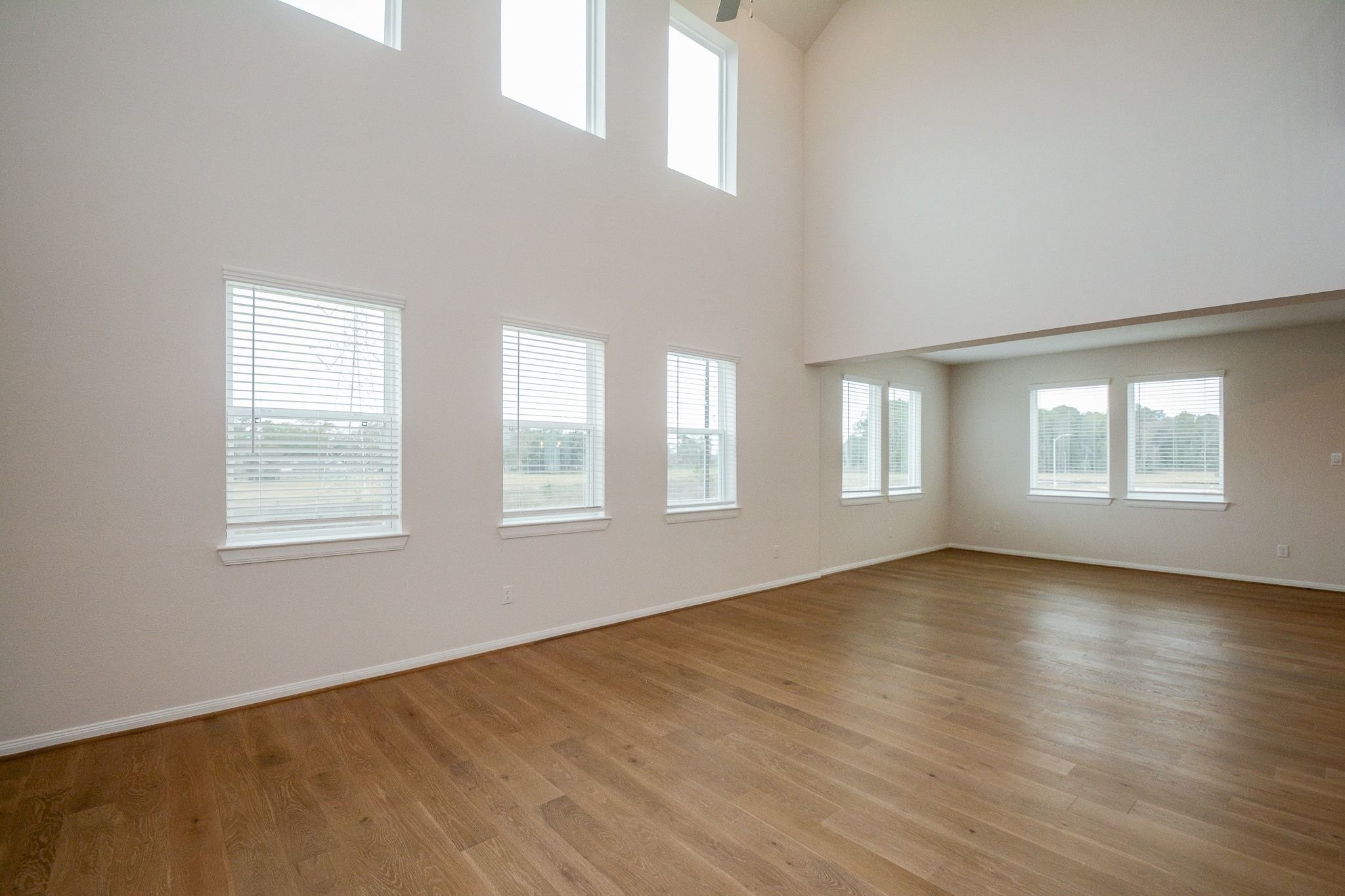 20629 Dynamic Court Humble, TX 77338 - Photo 3 of 36 an empty room with wooden floor and windows