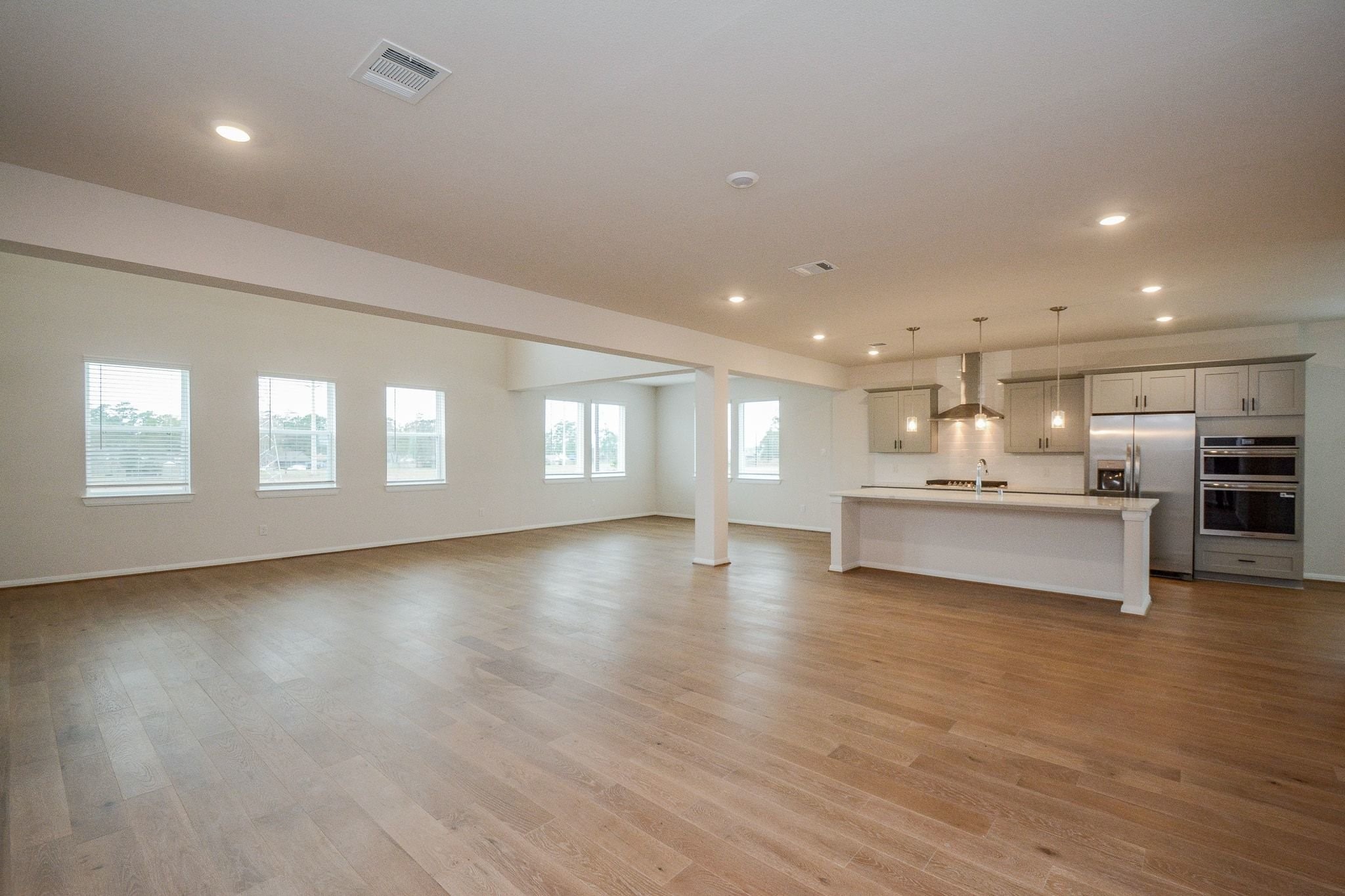 20629 Dynamic Court Humble, TX 77338 - Photo 6 of 36 a view of an empty room with window and wooden floor