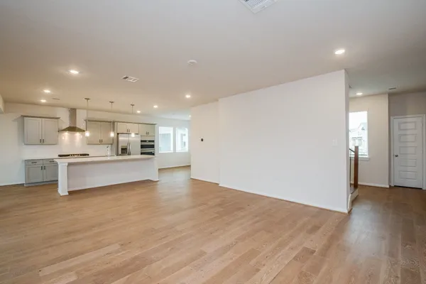 a view of kitchen with kitchen island and stainless steel appliances