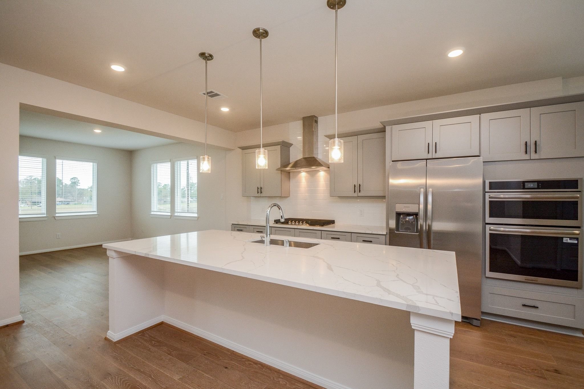 20629 Dynamic Court Humble, TX 77338 - Photo 8 of 36 a large kitchen with stainless steel appliances a large counter top oven and cabinets