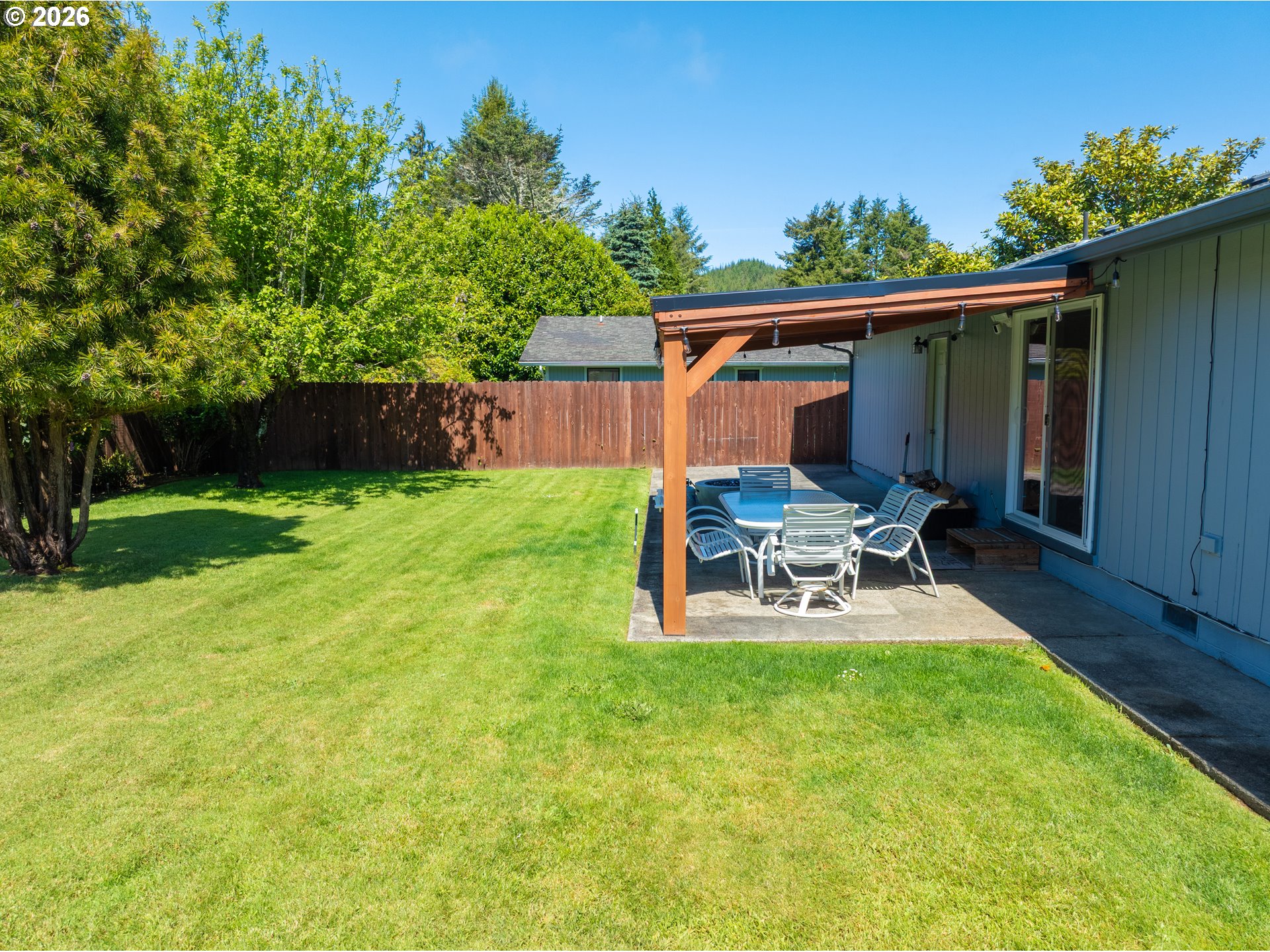 412 Camellia Court Reedsport, OR 97467 - Photo 42 of 48 a view of a chair and table in backyard of the house