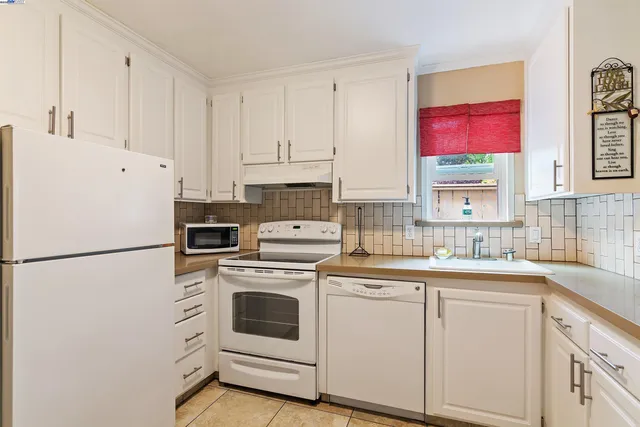 a white refrigerator freezer sitting inside of a kitchen
