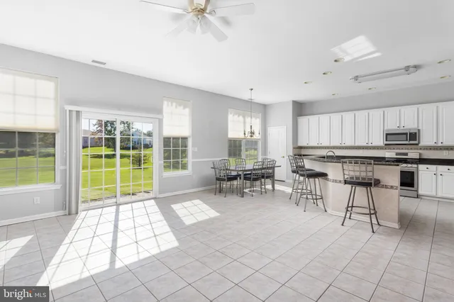 a view of a kitchen with microwave and cabinets
