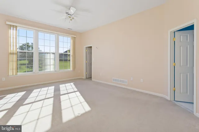 an empty room with windows and closet