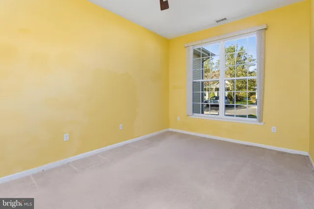 a view of a big room with windows