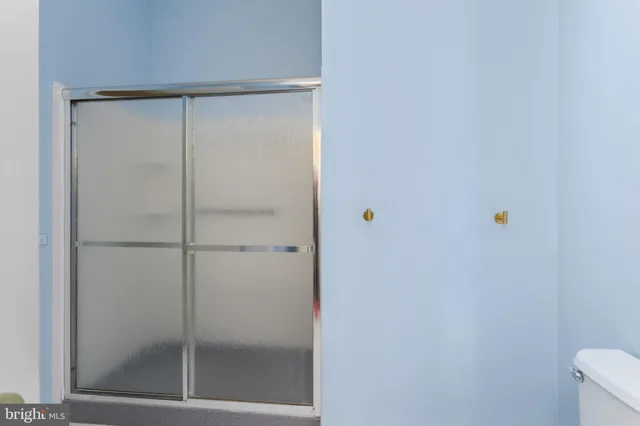 a bathroom with a glass shower door