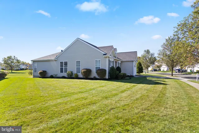 a house view with swimming pool in front of it