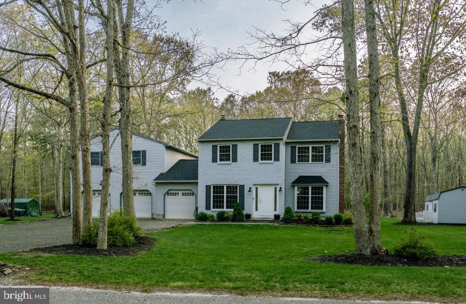 a view of house with a yard