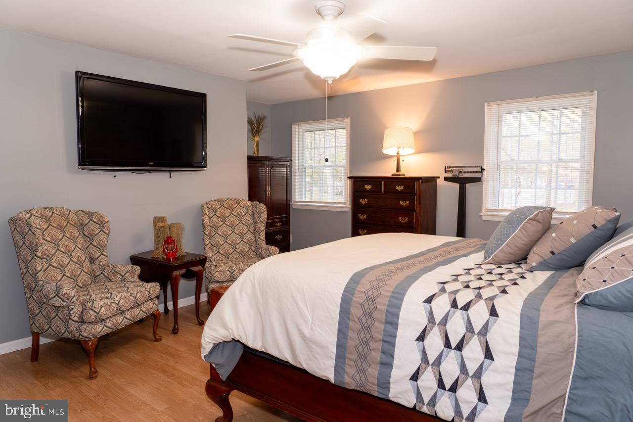 17 Red Oak Drive Tabernacle, NJ 08088 - Photo 23 of 45 a bedroom with a bed a couch and a flat screen tv