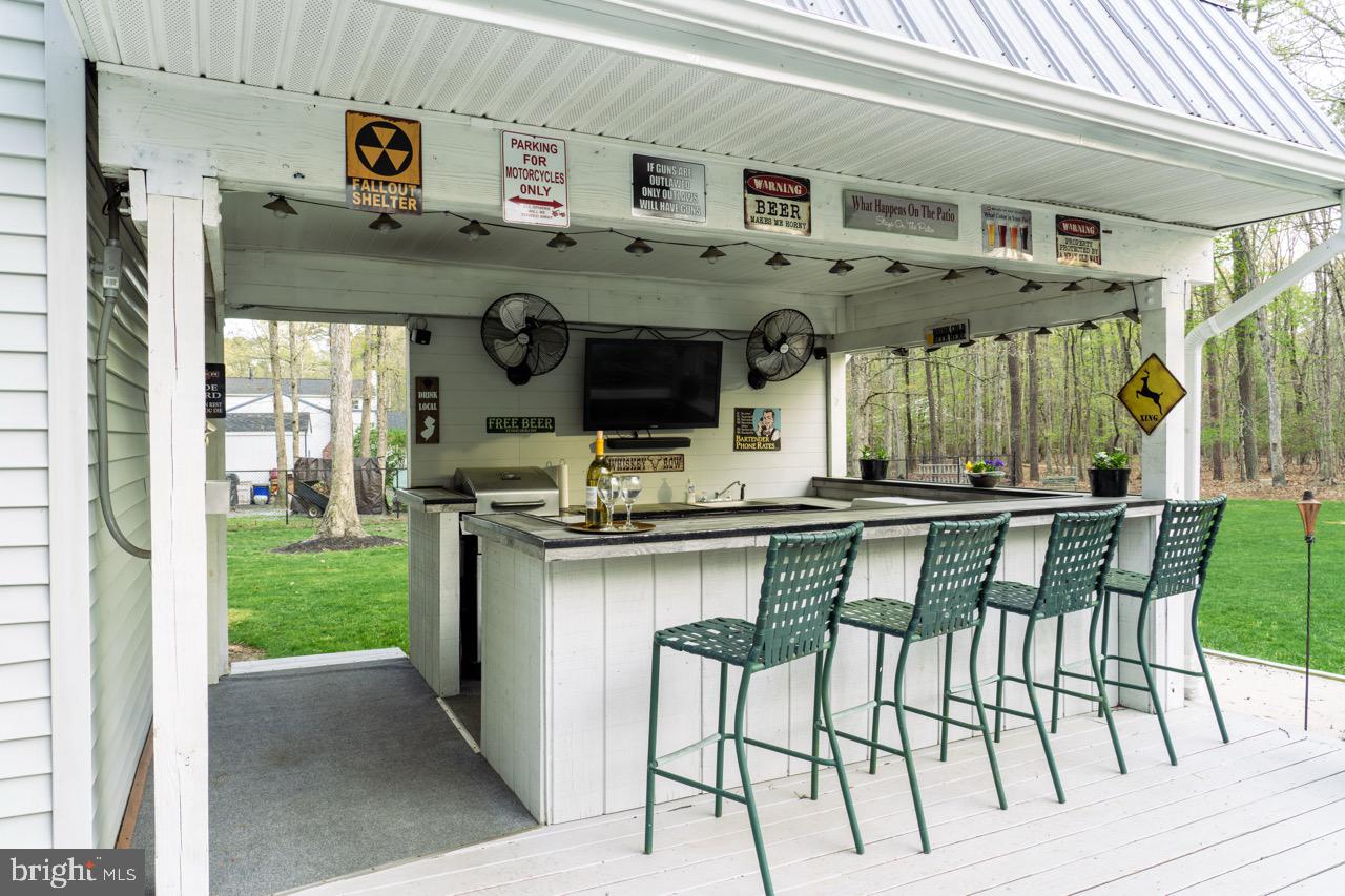 17 Red Oak Drive Tabernacle, NJ 08088 - Photo 38 of 45 a kitchen with stainless steel appliances granite countertop a kitchen island a stove and a view of living room