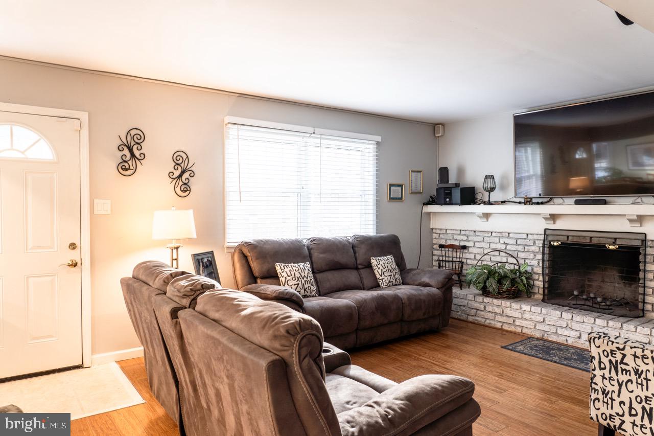 17 Red Oak Drive Tabernacle, NJ 08088 - Photo 5 of 45 a living room with furniture a flat screen tv and a fireplace