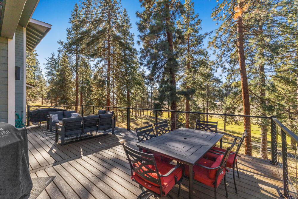 11750 Merganser Road Klamath Falls, OR 97601 - Photo 47 of 66 a view of a patio with table and chairs with wooden floor and fence