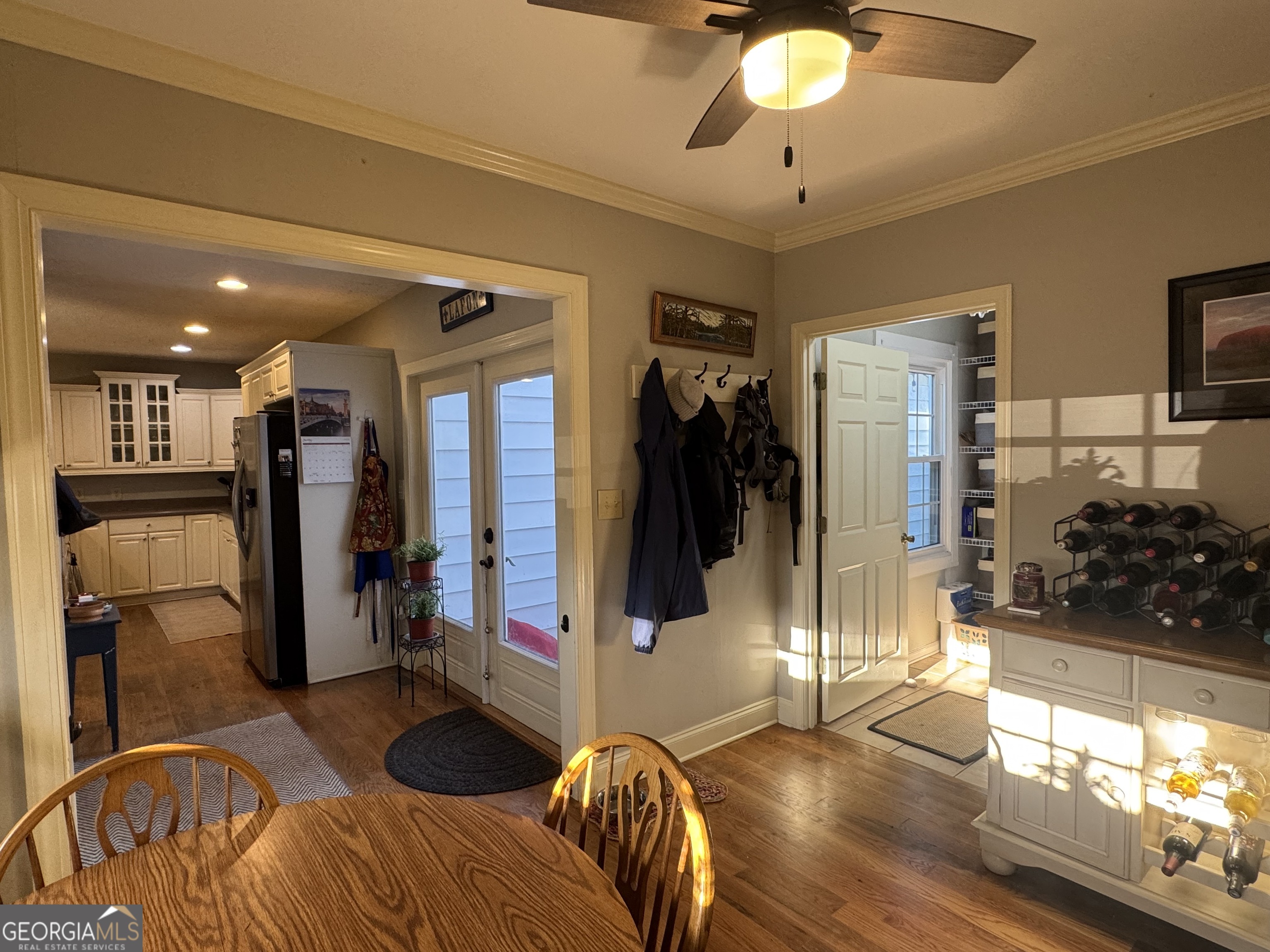 722 Maple Drive Griffin, GA 30224 - Photo 13 of 28 a living room with furniture a chandelier and a flat screen tv