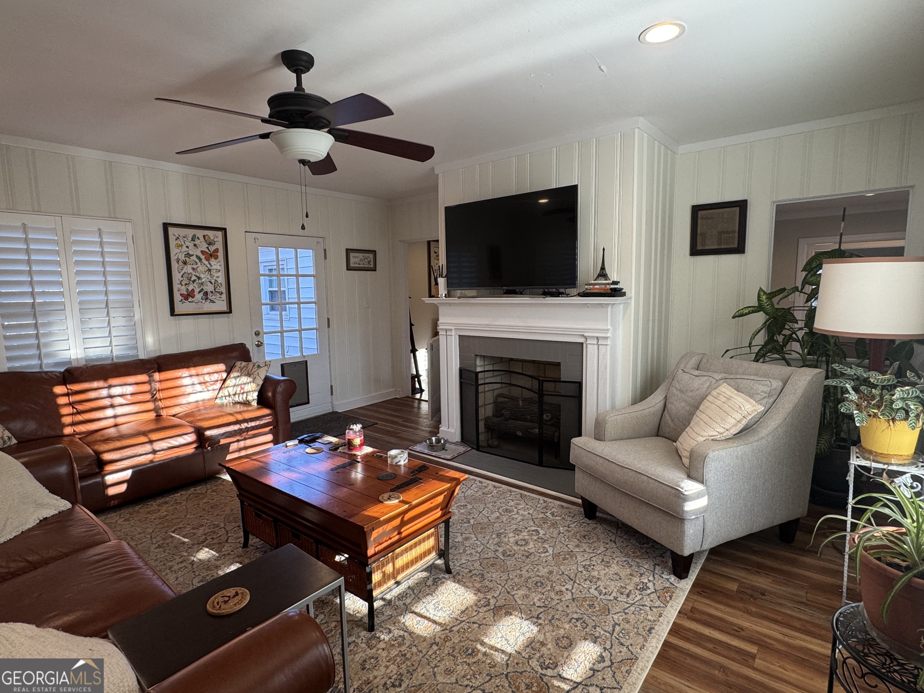722 Maple Drive Griffin, GA 30224 - Photo 16 of 28 a living room with furniture a flat screen tv and a fireplace