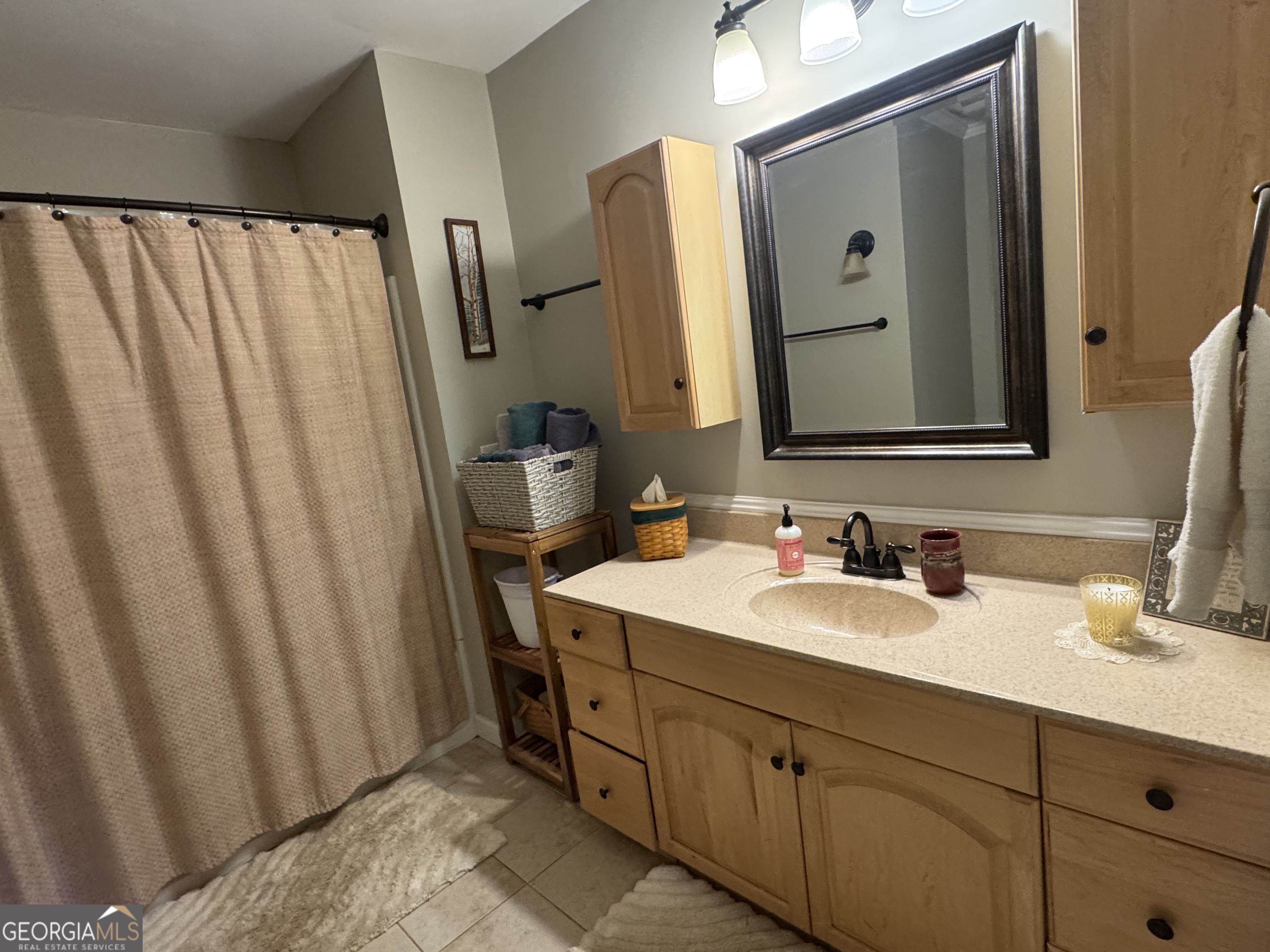 722 Maple Drive Griffin, GA 30224 - Photo 19 of 28 a bathroom with a double vanity sink and mirror
