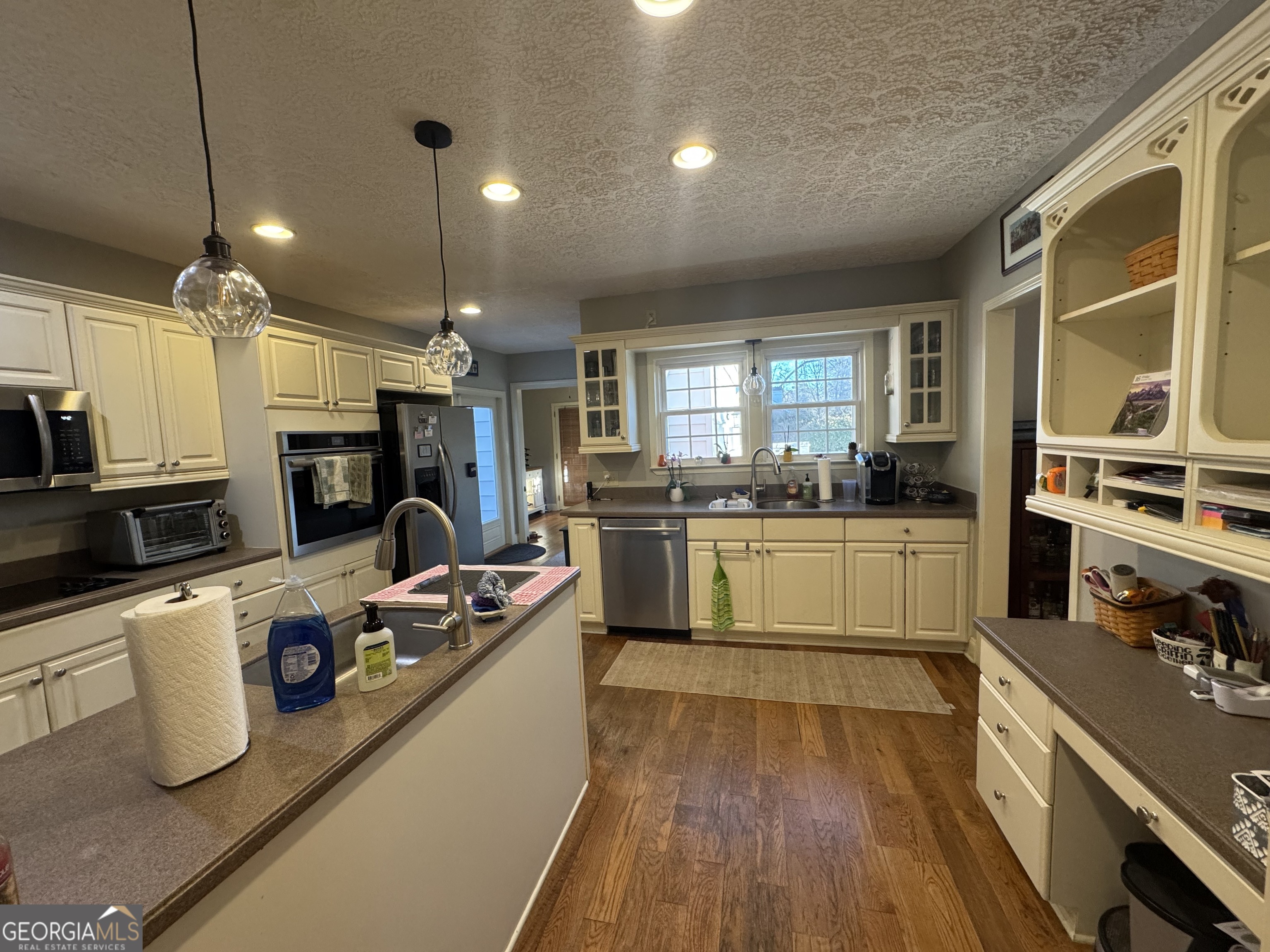 722 Maple Drive Griffin, GA 30224 - Photo 21 of 28 a kitchen with kitchen island a counter top space a sink stainless steel appliances and cabinets