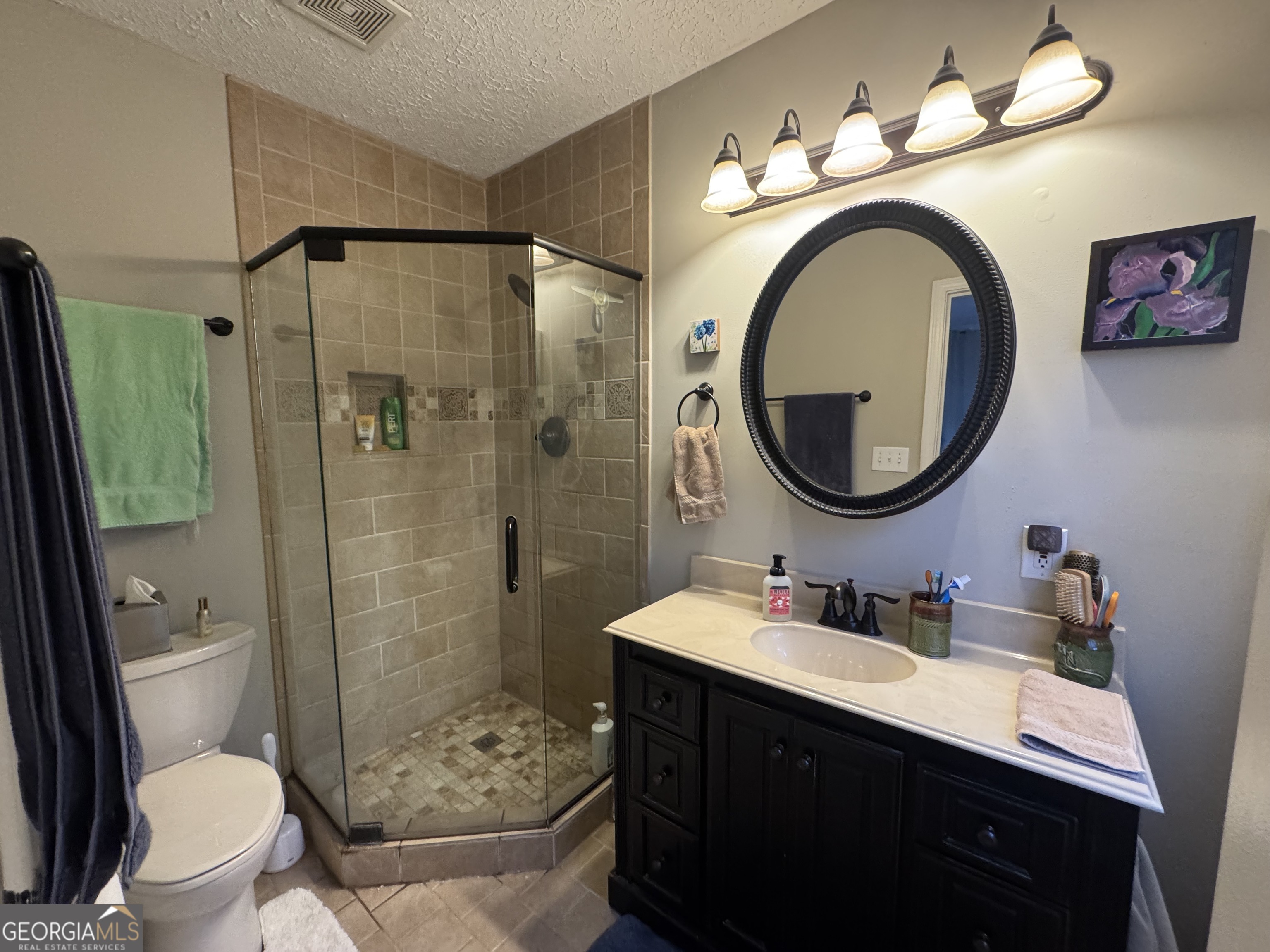 722 Maple Drive Griffin, GA 30224 - Photo 22 of 28 a bathroom with a sink a toilet and a mirror
