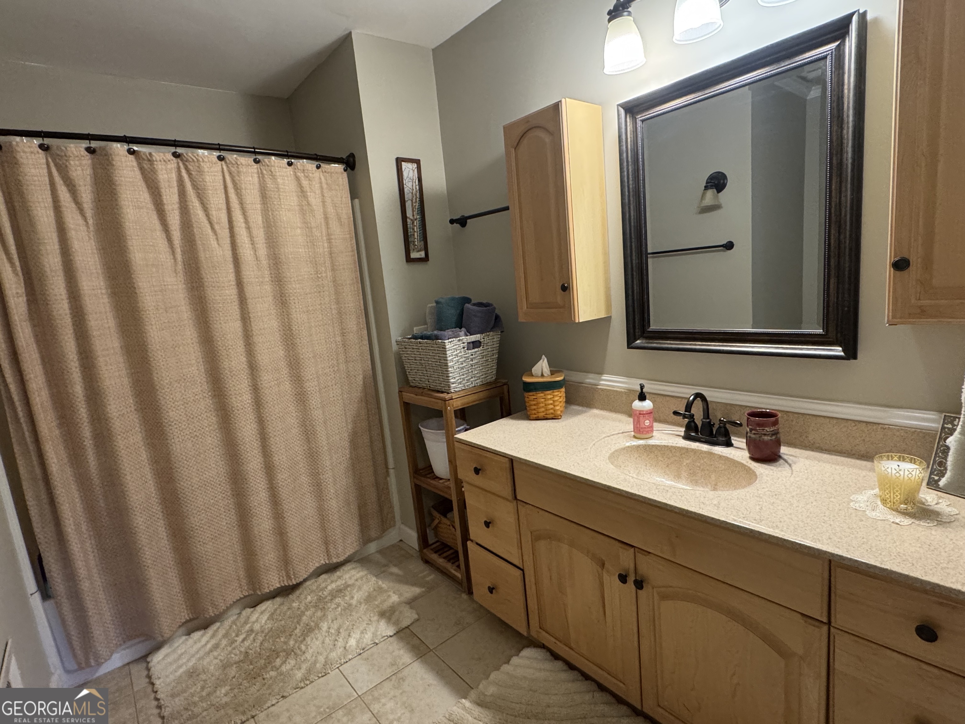 722 Maple Drive Griffin, GA 30224 - Photo 23 of 28 a bathroom with a double vanity sink and mirror