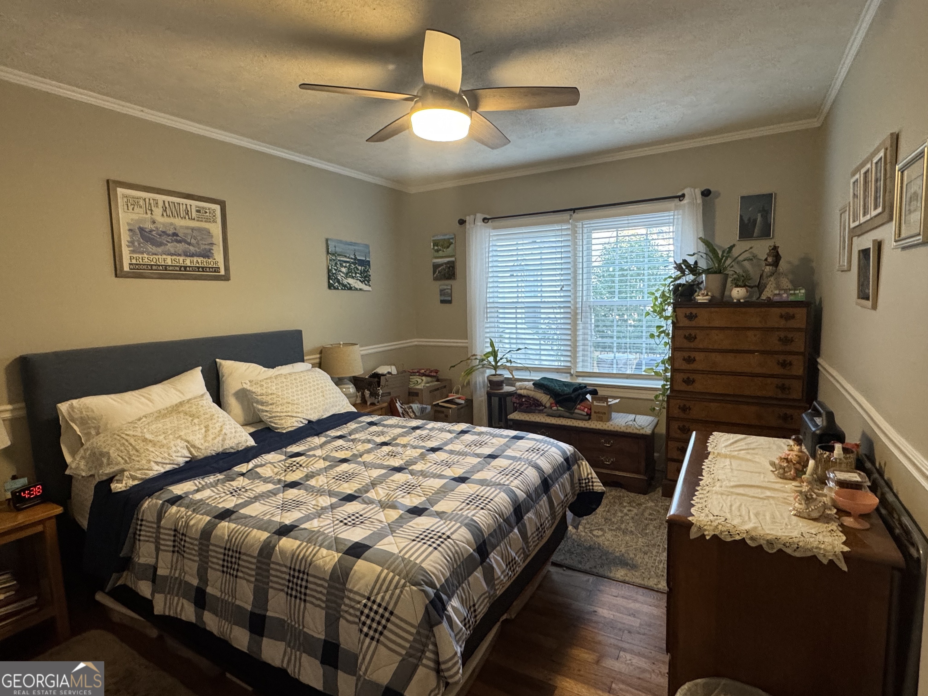 722 Maple Drive Griffin, GA 30224 - Photo 24 of 28 a bedroom with a bed and a chandelier