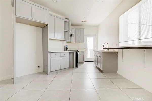 a kitchen with a stove a sink and a refrigerator