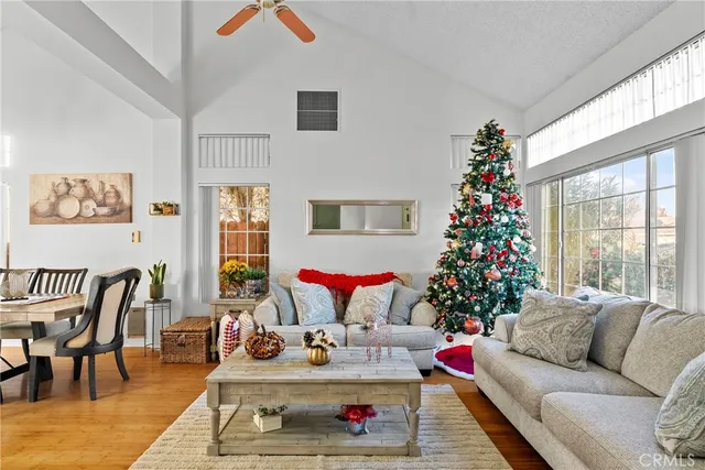 a living room with furniture and flowers