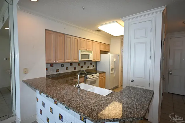 a kitchen with stainless steel appliances granite countertop a granite counter tops and a refrigerator