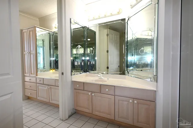 a bathroom with a granite countertop sink mirror and bathtub