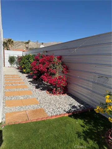 a view of a pathway with a garden