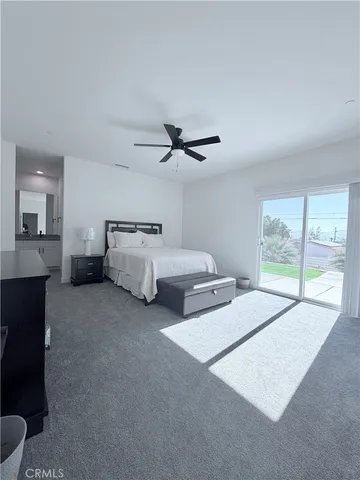 a bed room with bed and window