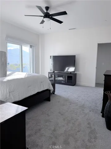 a bedroom with a bed and a chair