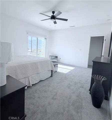 a bedroom with a bed and a chair