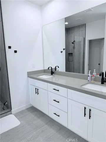 a bathroom with a double vanity sink and a mirror