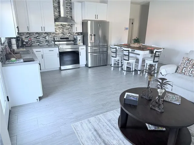 a kitchen with a table chairs stove and refrigerator