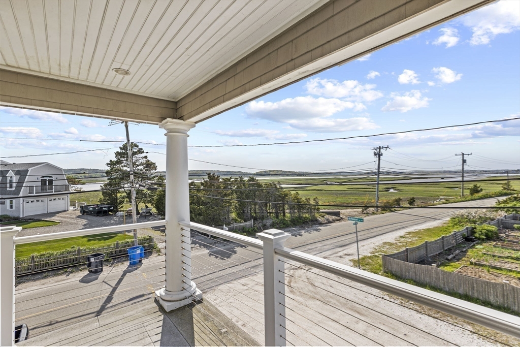 98 Central Avenue Scituate, MA 02066 - Photo 23 of 37 a view of a balcony and floor to ceiling windows with wooden floor