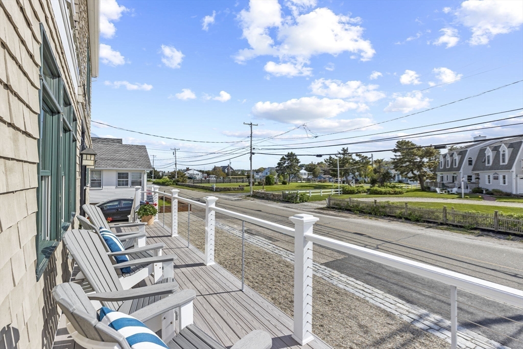 98 Central Avenue Scituate, MA 02066 - Photo 30 of 37 a view of a patio with table and chairs with wooden floor